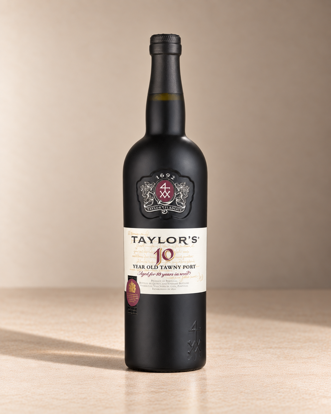 10yr Tawny Port single wine bottle on a warm beige studio background