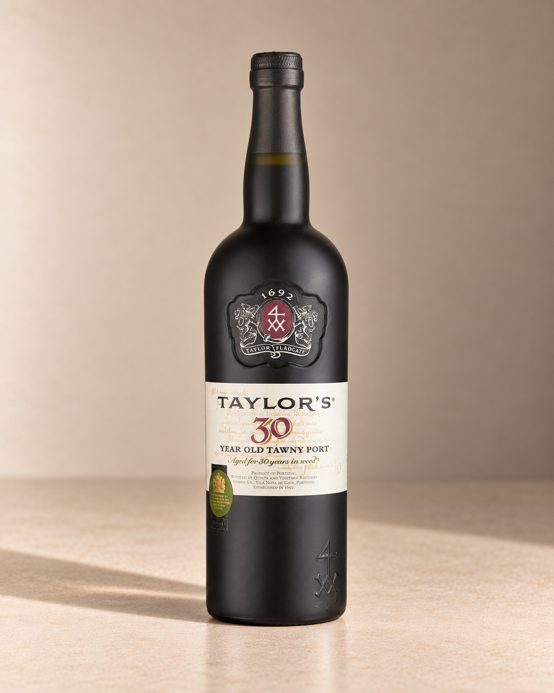 30yr Tawny Port single wine bottle on a warm beige studio background