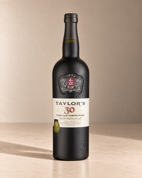 30yr Tawny Port single wine bottle on a warm beige studio background