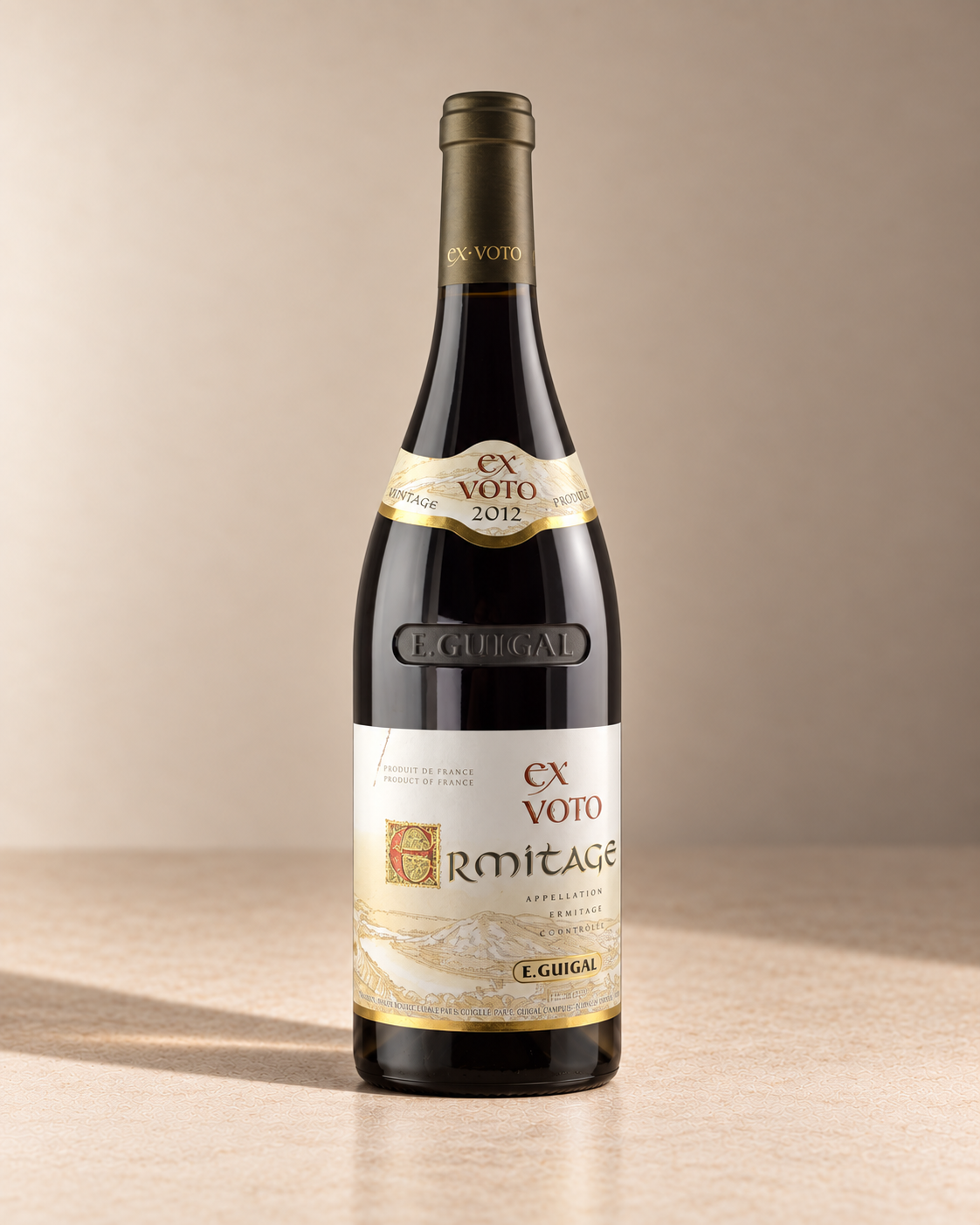 'Ex Voto Rouge' Ermitage 2012 single wine bottle on a warm beige studio background