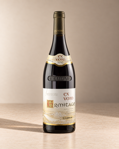 'Ex Voto Rouge' Ermitage 2012 single wine bottle on a warm beige studio background