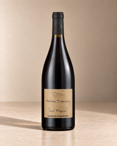 'Les Poyeux' Saumur-Champigny 2022 single wine bottle on a warm beige studio background