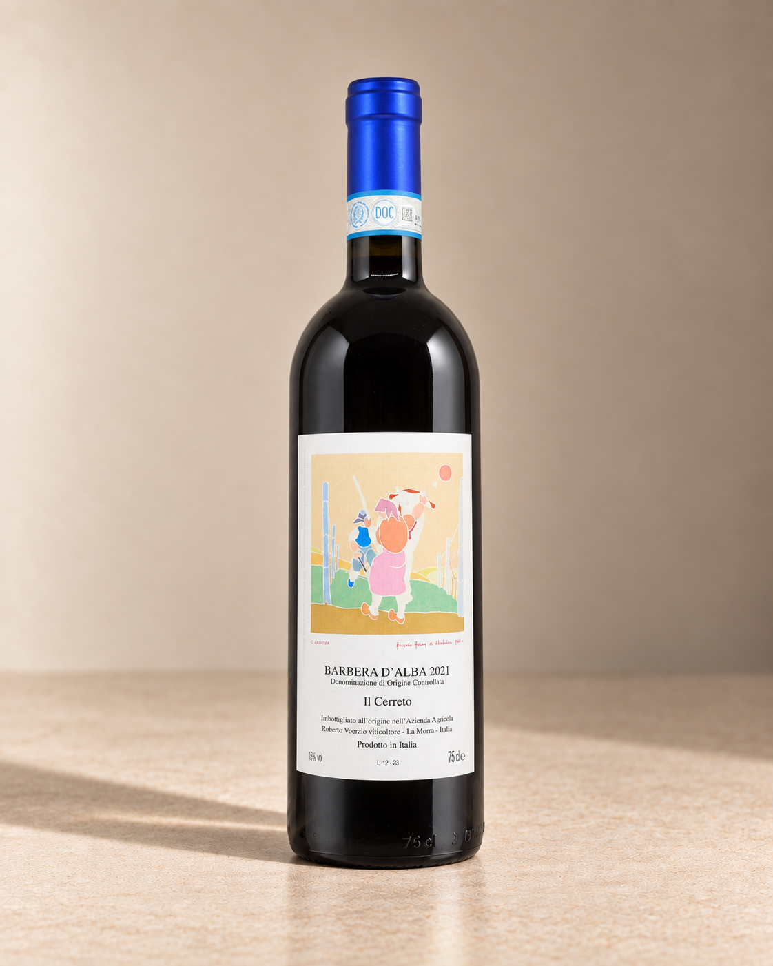 'Il Cerreto' Barbera d'Alba 2021 single wine bottle on a warm beige studio background