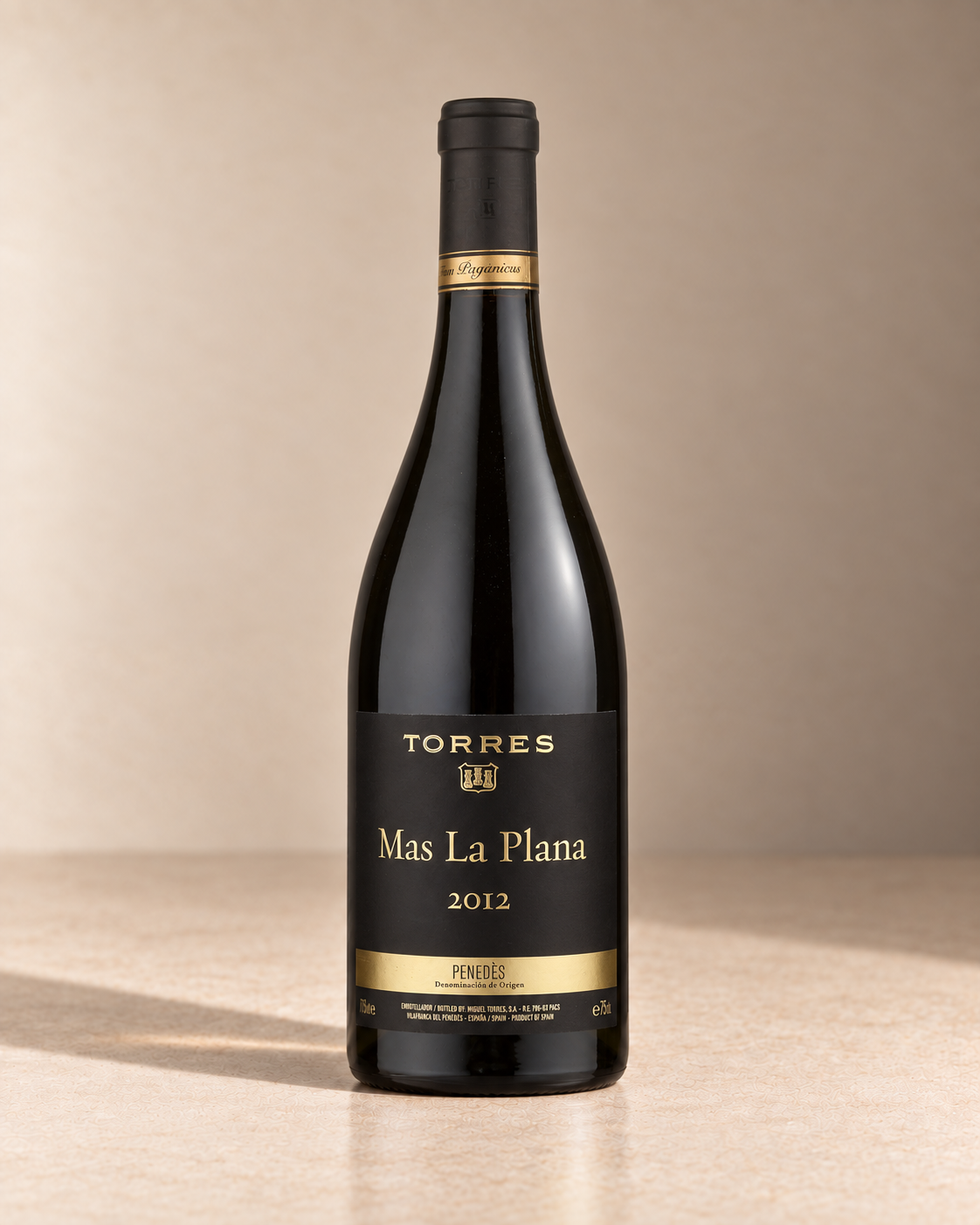 'Mas La Plana' Cabernet Sauvignon 2012 single wine bottle on a warm beige studio background