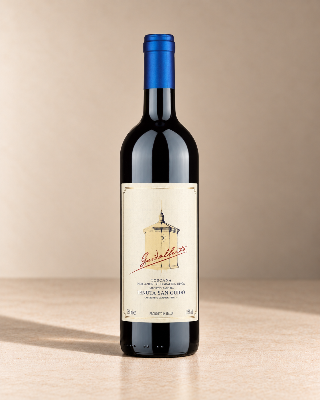 'Guidalberto' Merlot Blend 2022 single wine bottle on a warm beige studio background