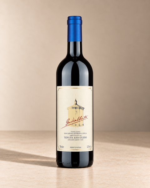 'Guidalberto' Merlot Blend 2022 single wine bottle on a warm beige studio background