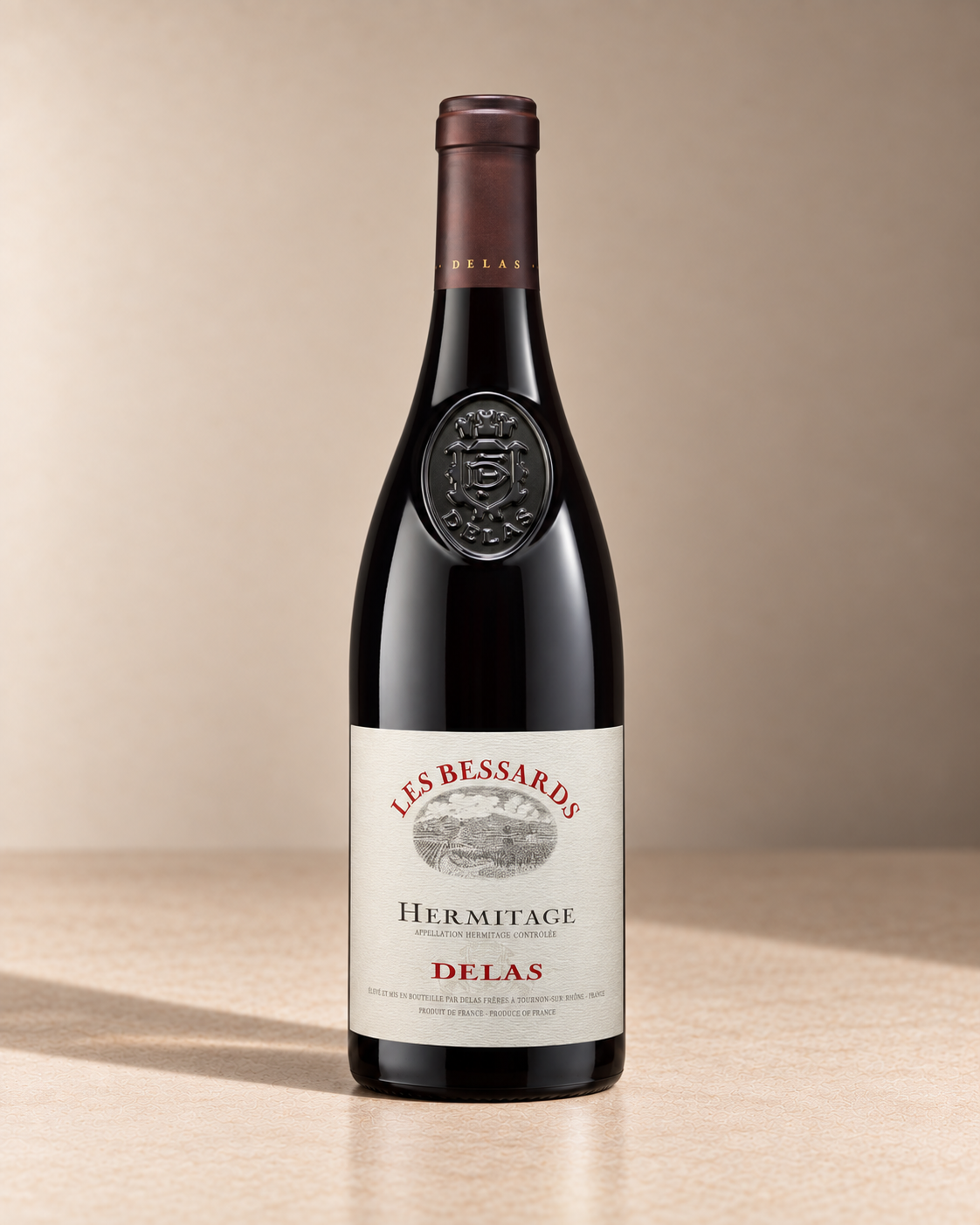 'Les Bessards' Hermitage 2012 single wine bottle on a warm beige studio background