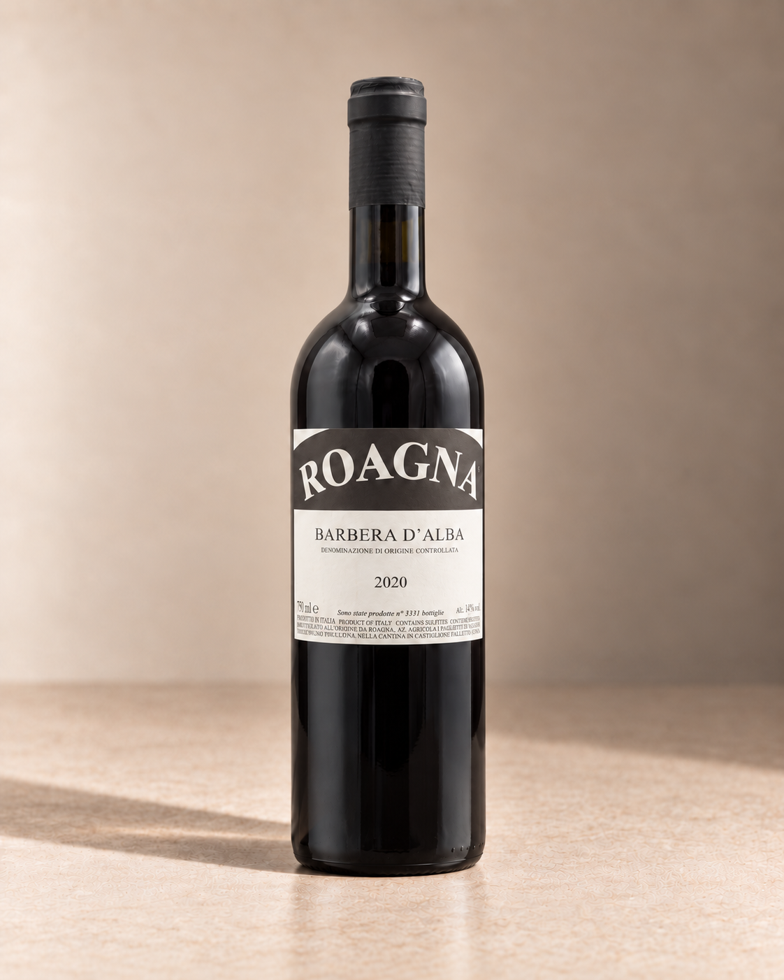 Barbera d'Alba 2020 single wine bottle on a warm beige studio background