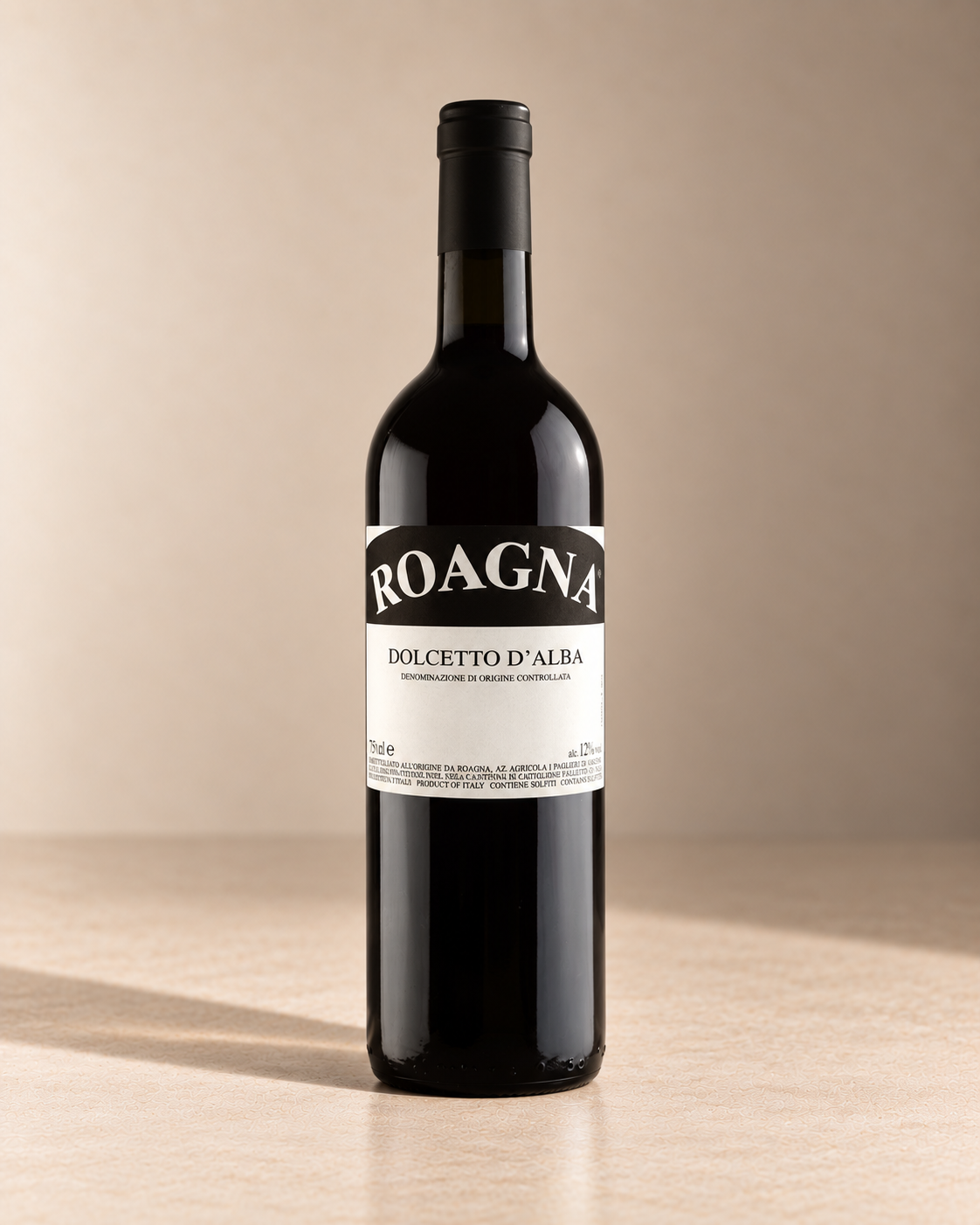 Dolcetto d'Alba 2024 single wine bottle on a warm beige studio background