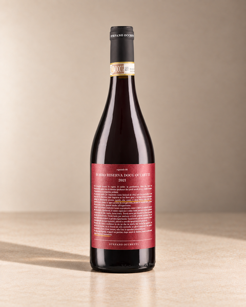 Roero Rosso Riserva 2021 single wine bottle on a warm beige studio background