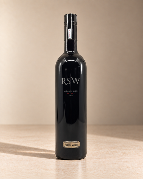 'RSW' Shiraz 2015 single wine bottle on a warm beige studio background