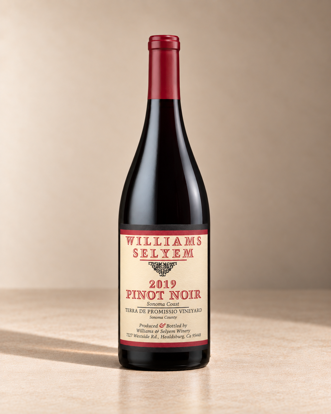 'Sonoma Coast' Pinot Noir 2019 single wine bottle on a warm beige studio background