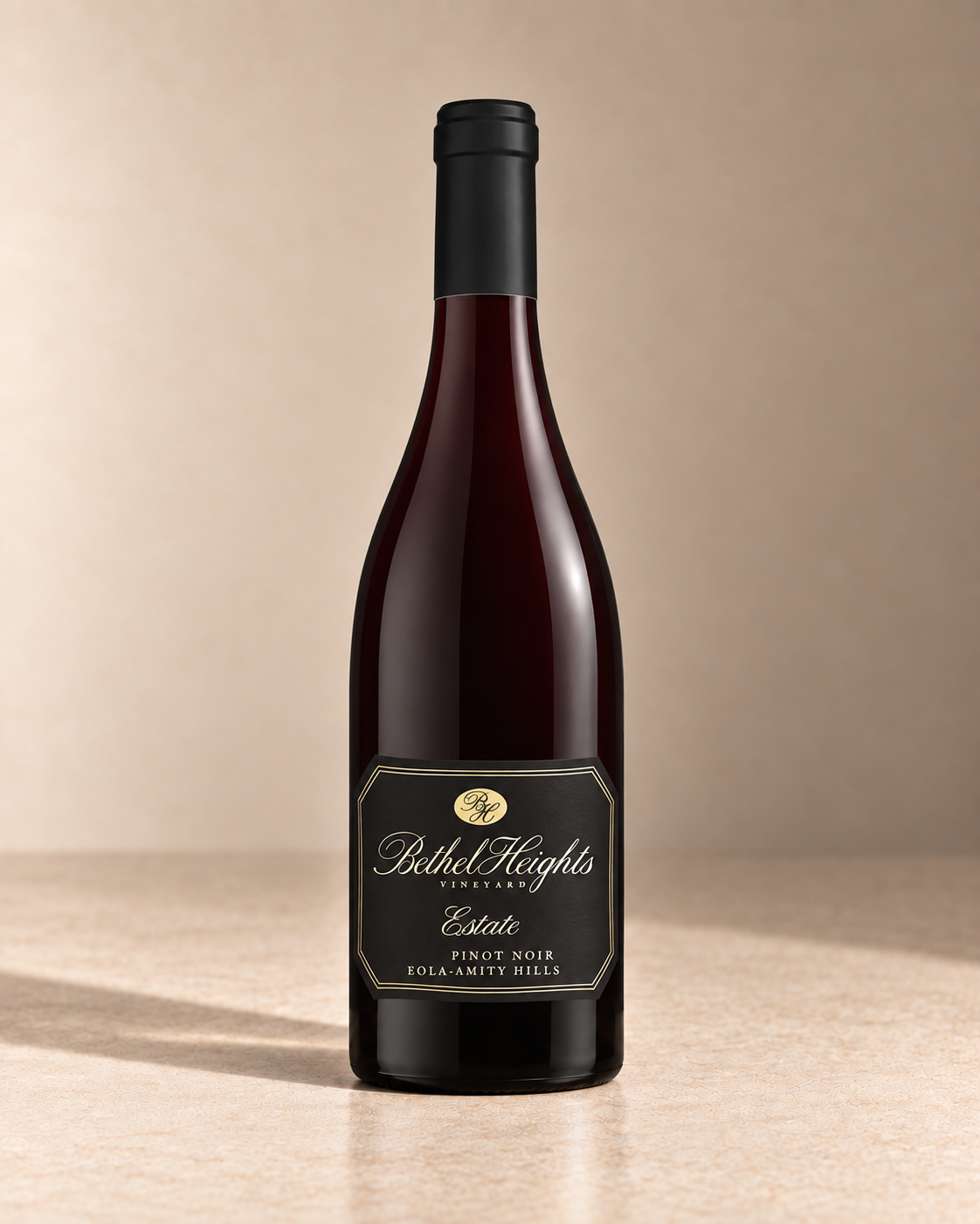 'Estate' Pinot Noir 2019 single wine bottle on a warm beige studio background
