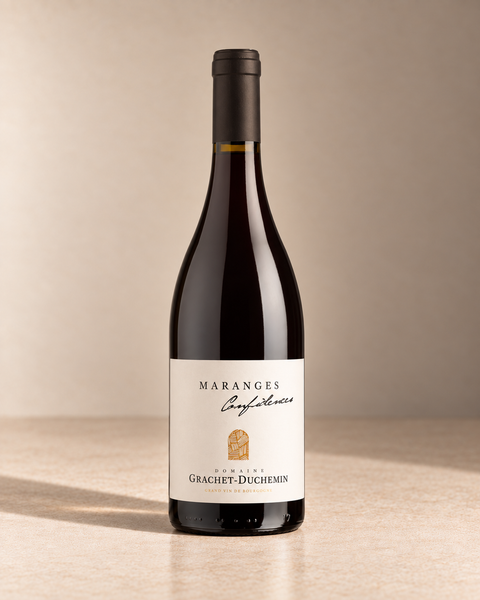 'Confidences' Maranges 2023 single wine bottle on a warm beige studio background