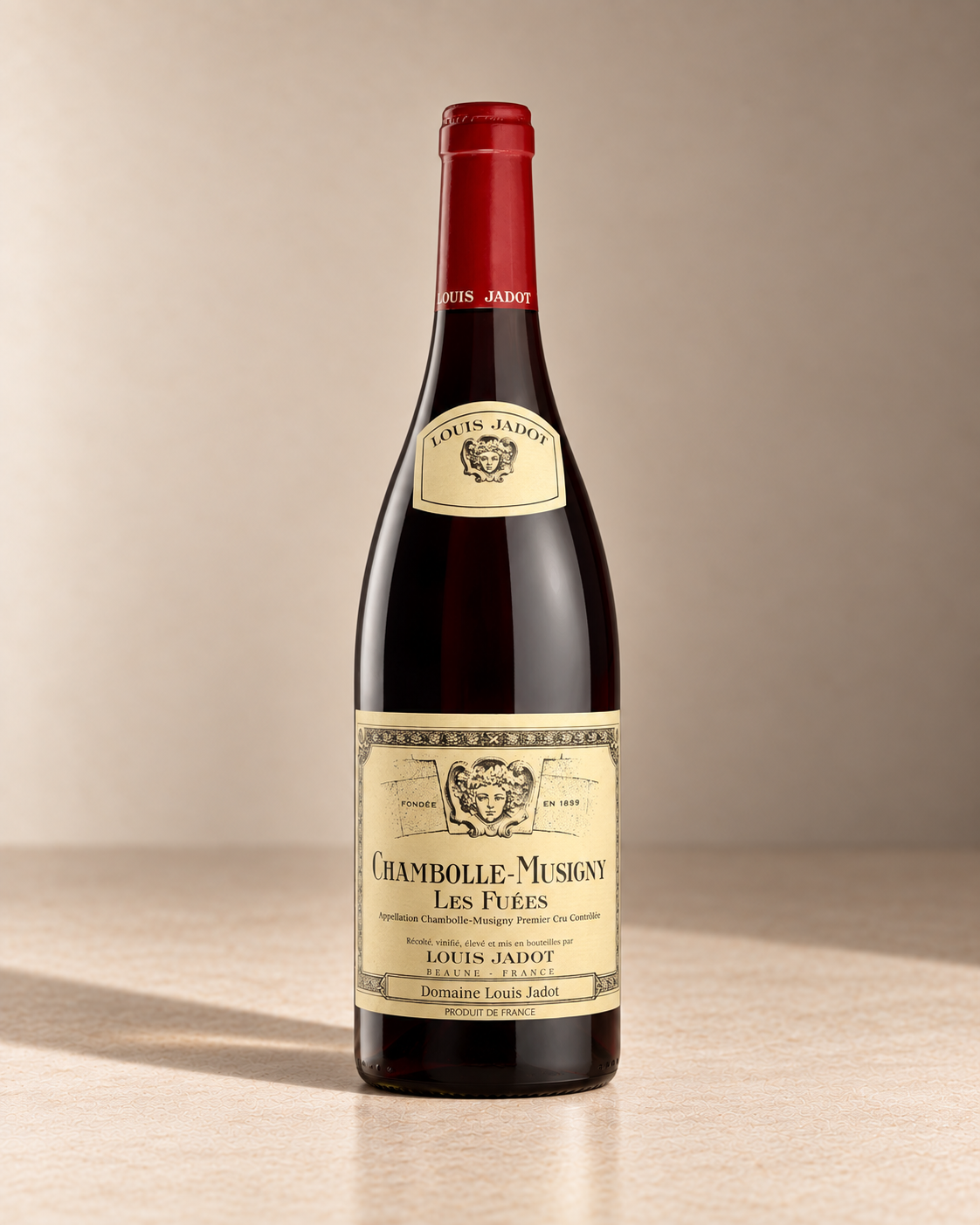 'Fuees' Chambolle-Musigny 2021 single wine bottle on a warm beige studio background