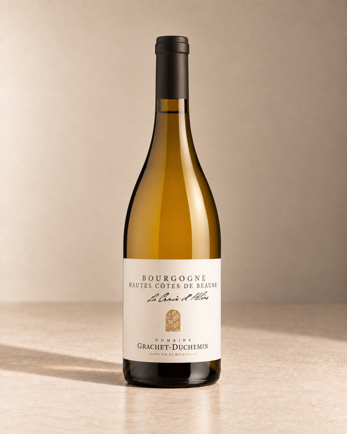'La Croix d'Helios' Hautes-Côtes de Beaune 2024 single wine bottle on a warm beige studio background