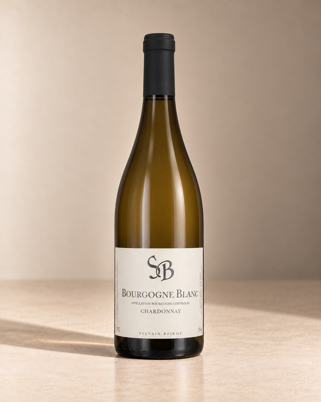 Bourgogne Blanc 2022 single wine bottle on a warm beige studio background