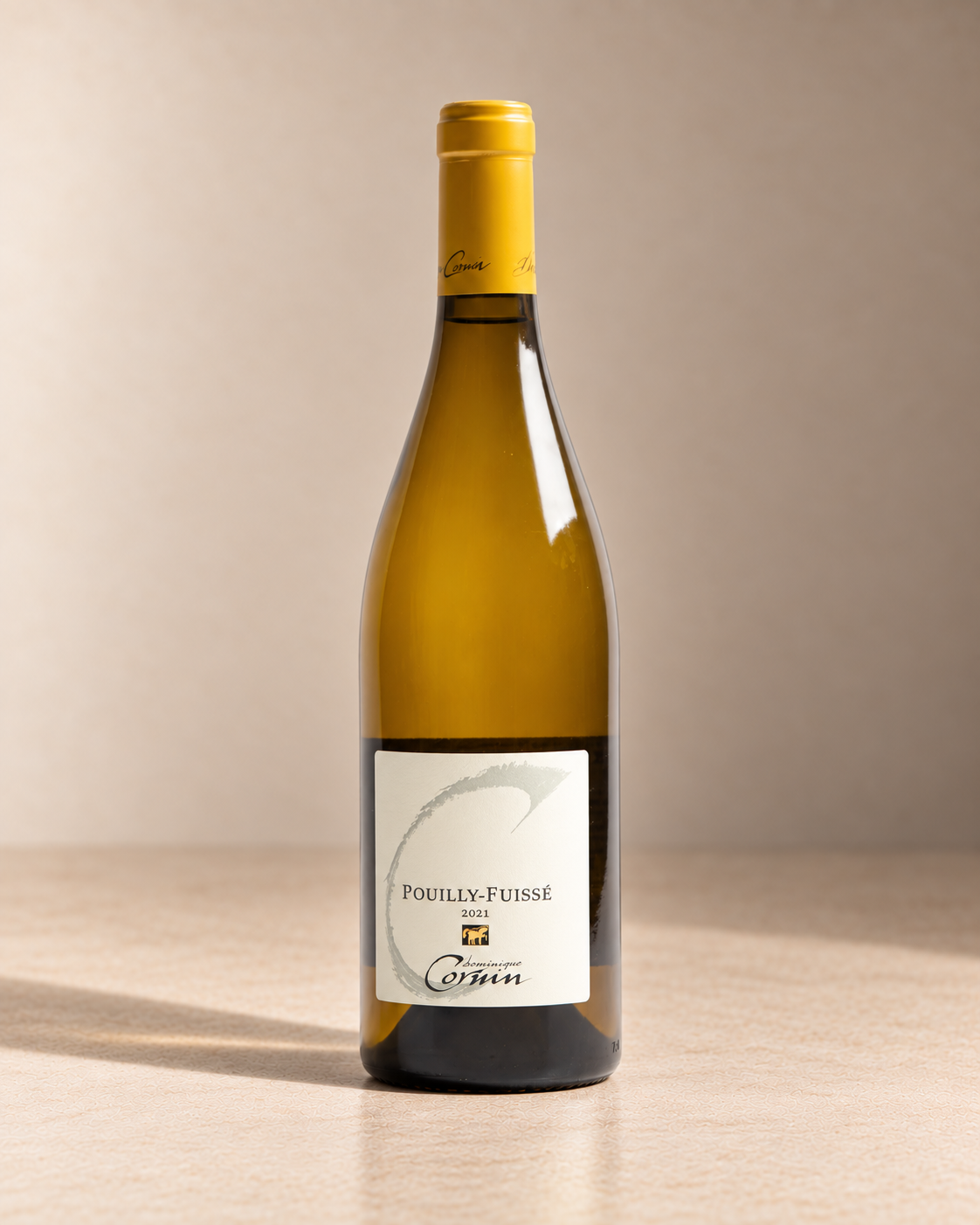 Pouilly Fuissé Villages 2024 single wine bottle on a warm beige studio background
