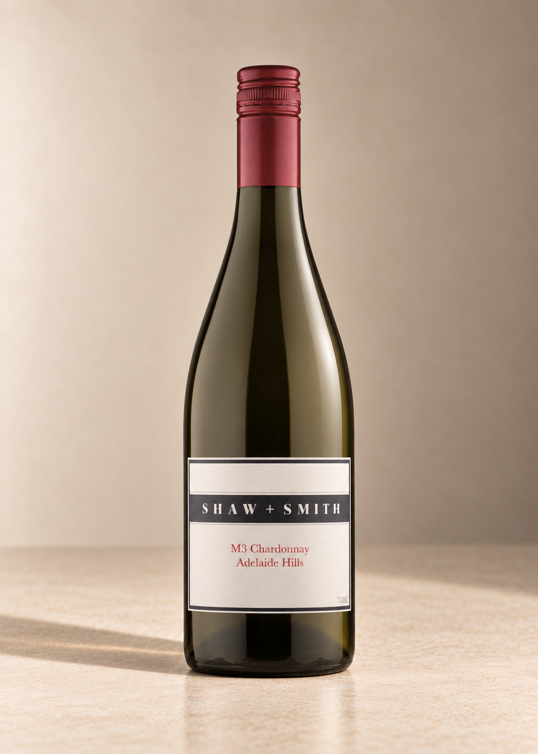 'M3' Chardonnay 2017 single wine bottle on a warm beige studio background