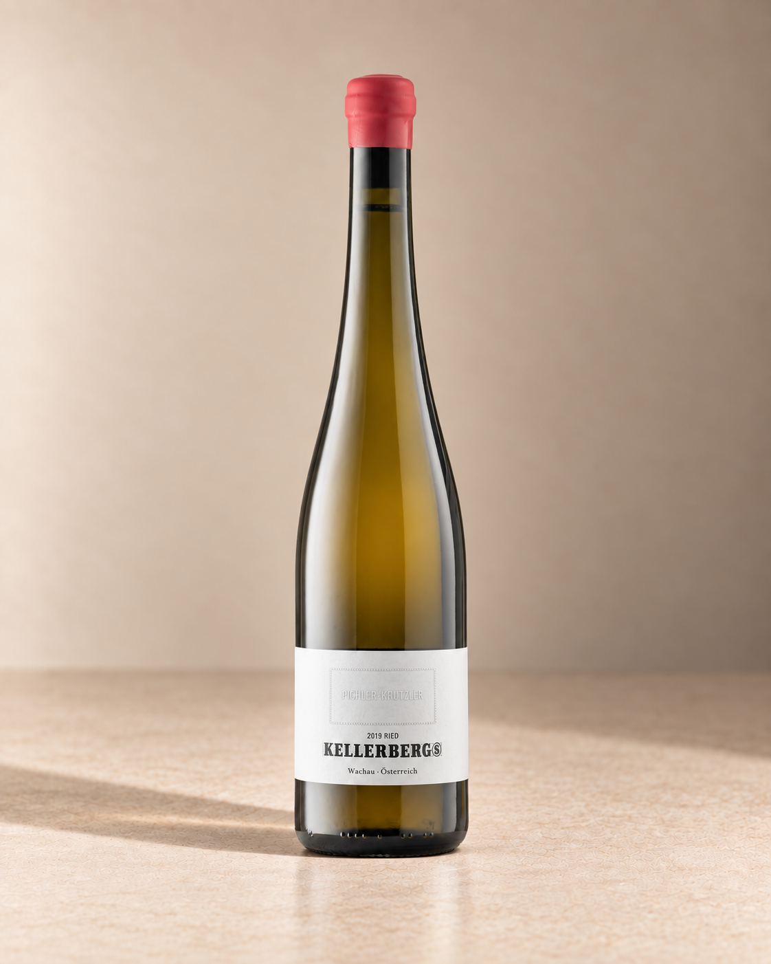 'Kellerberg S' Grüner Veltliner 2019 single wine bottle on a warm beige studio background