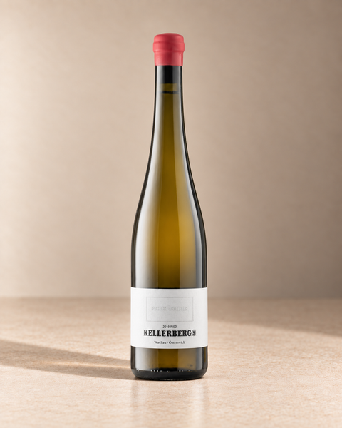 'Kellerberg S' Grüner Veltliner 2019 single wine bottle on a warm beige studio background