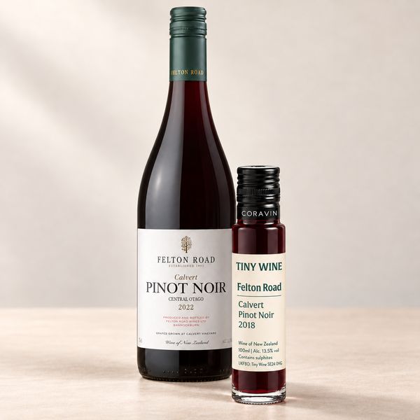 Felton Road Calvert Pinot Noir 2018 100ml Tiny Wine tube beside a representative bottle labelled 2022, on a warm beige studio background