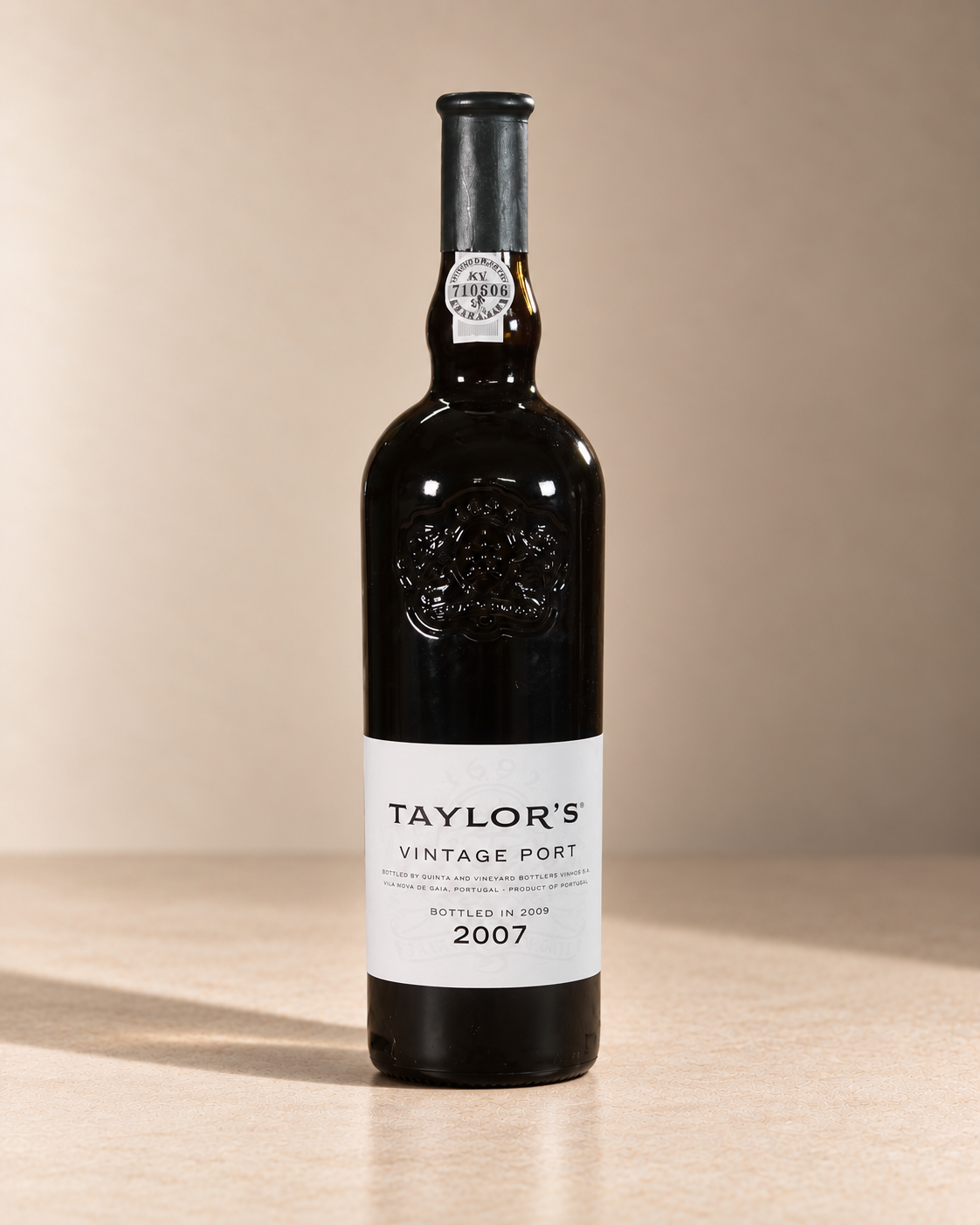 Port 2007 single wine bottle on a warm beige studio background